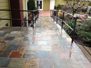 Square Tile Flagstone Entryway and Ramp Leading to Stamped Concrete Patio